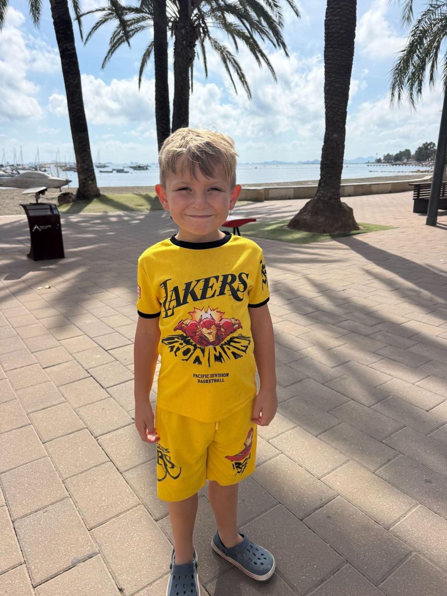 Hudson, Brett and Rachael’s son, in a yellow T-shirt on the same seafront promenade.